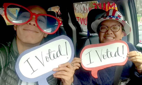 Students holding "I voted" signs